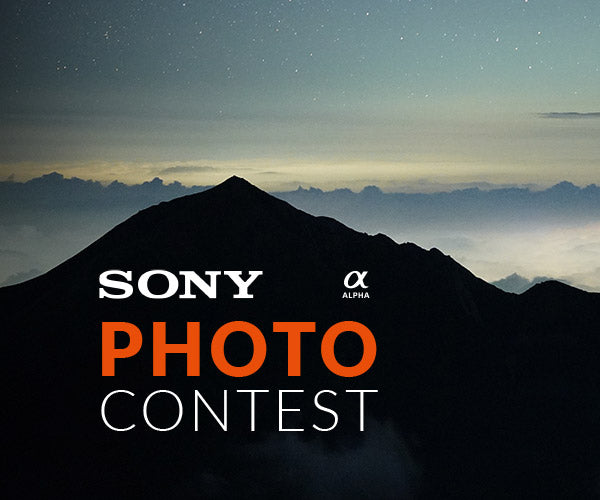 Sony Photo Contest with image of a mountain cast in shadow before a lit background of fog